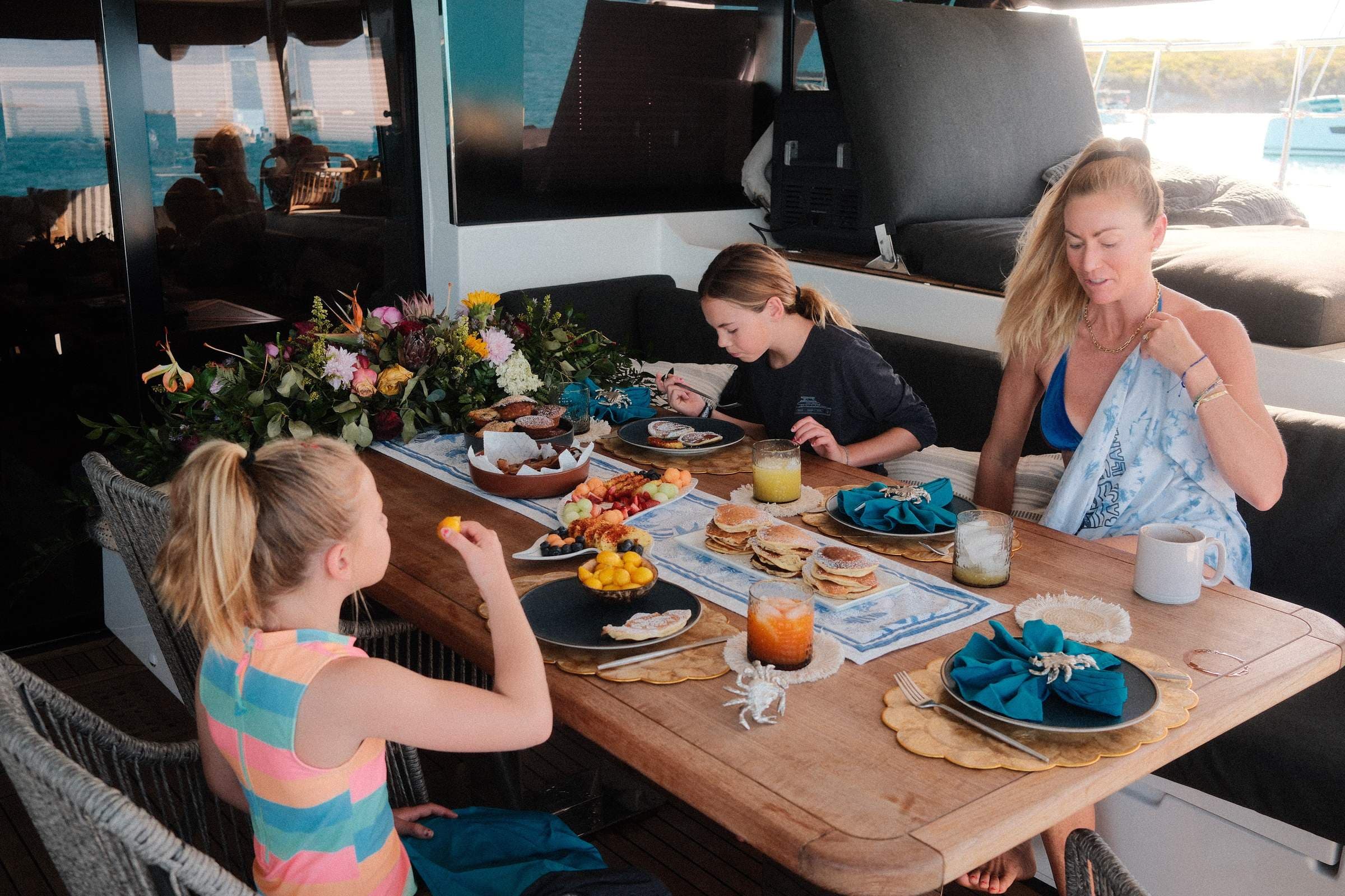 Family breakfast on deck — golden morning light